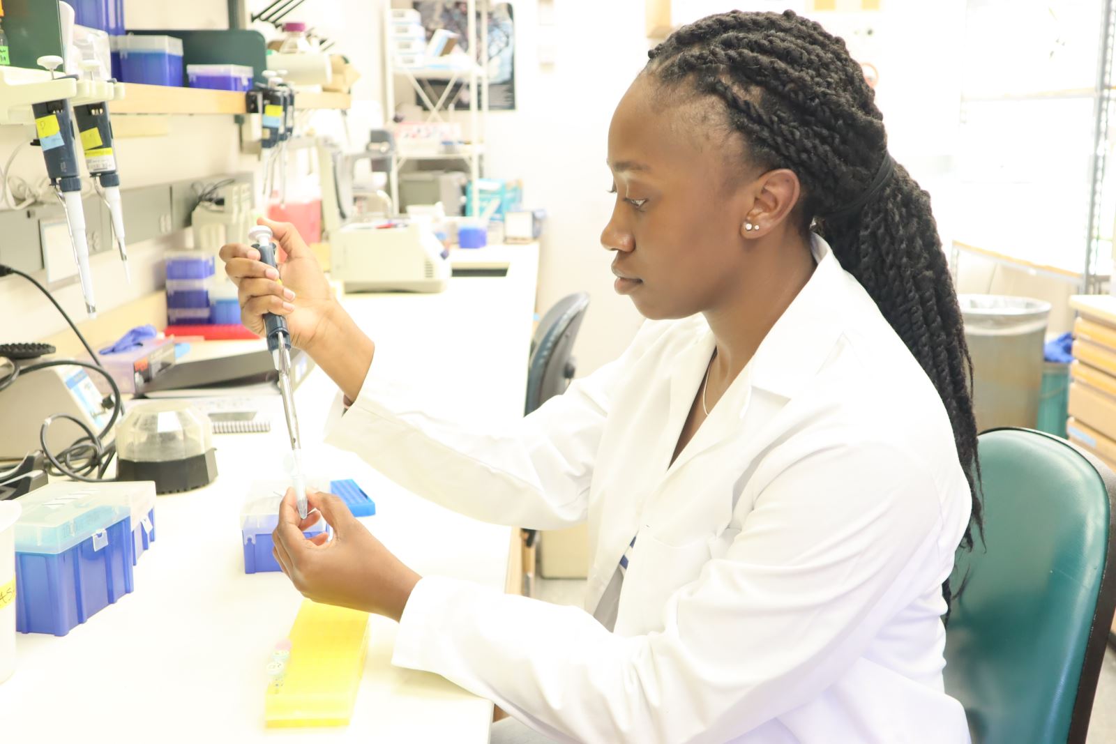 Student pipettes in the lab