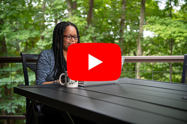 Image: Woman works on her laptop while sitting on her deck. Photo links to YouTube video about OHIO''s online learning.